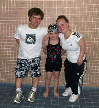 Ellie and Matt with a young swimmer